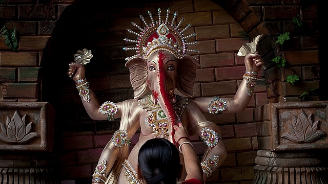 A Bangladeshi Hindu devotee worships Lord Ganesh in Dhaka, Bangladesh. (Allison Joyce/GettyImages)