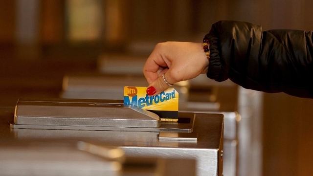 A woman swipes her MetroCard in New York (ANADOLU AGENCY VIA GETTY IMAGES)