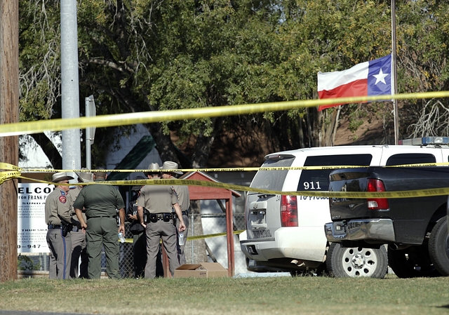  Law enforcement officials gather near the First Baptist Church following the shooting. (Erich Schlegel/Getty Images)