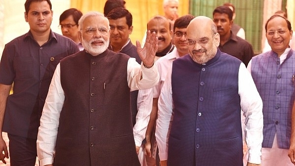 Prime Minister Narendra Modi and BJP president Amit Shah arrive to attend the Diwali Mangal Milan with journalists at BJP headquarters in New Delhi. (Raj K Raj/Hindustan Times via Getty Images)