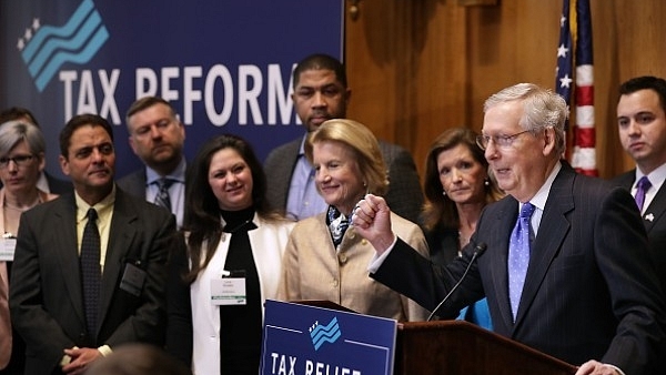 Pumping his fist, Senate Majority Leader Mitch McConnell (R-KY) addresses a tax reform news conference with Sen. Shelley Moore Capito (R-WV)  on Capitol Hill in Washington, DC. (Chip Somodevilla/Getty Images)