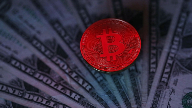 A visual representation of the digital Cryptocurrency, Bitcoin alongside US Dollars (Dan Kitwood/Getty Images)