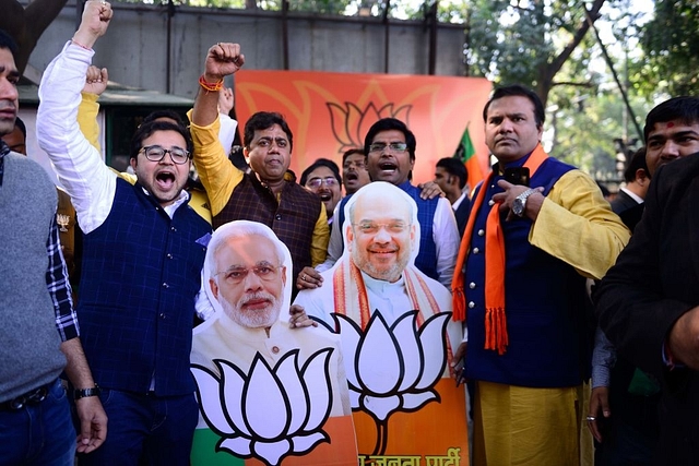 BJP supporters celebrate outside BJP office after victories in Gujarat and Himachal Pradesh elections on 18 December in New Delhi, India. (Pradeep Gaur/Mint via GettyImages)