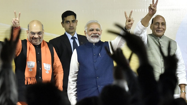 Prime Minister Narender Modi, BJP national president Amit Shah and Home Minister Rajnath Singh greet BJP workers after winning Gujarat and Himachal Pradesh elections at the party headquarters in New Delhi. (Sonu Mehta/Hindustan Times via GettyImages)