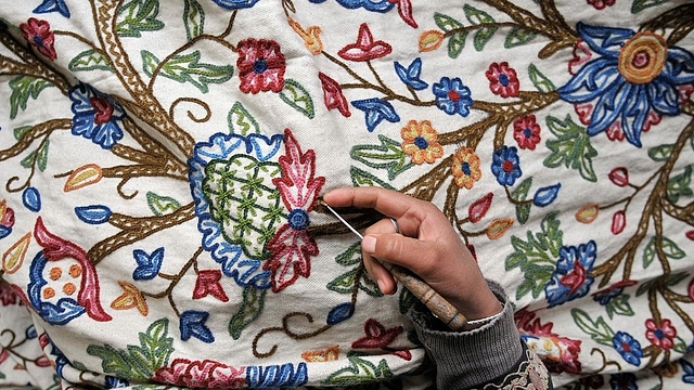 Kashmiri women doing intricate embroidery on window curtains (Waseem Andrabi/ Hindustan Times via Getty images)