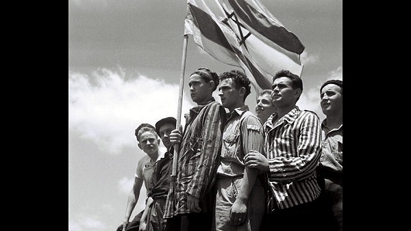 Jewish survivors stand on the deck of a refugee immigration ship at Haifa port, during the British Mandate of Palestine, in what would later become the state of Israel. (Zoltan Kluger/GPO via Getty Images)