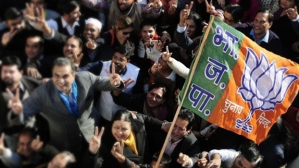 The BJP party workers celebrate the victory of the party in Gujarat and Himachal Pradesh at the party office in Chandigarh. (Keshav Singh/Hindustan Times)