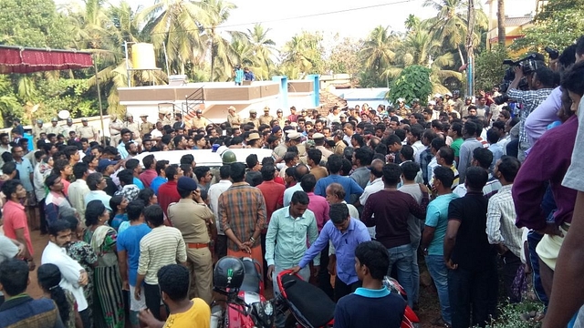 Protesters gather outside the house of Deepak Rao as police move his body to his house.&nbsp;