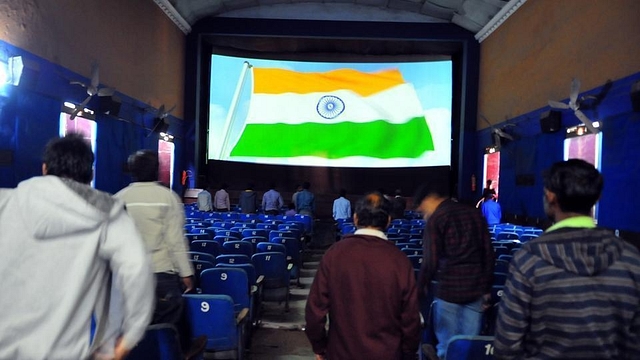 Audience standing for a national anthem in a theatre (Hindustan Times via Getty Images)