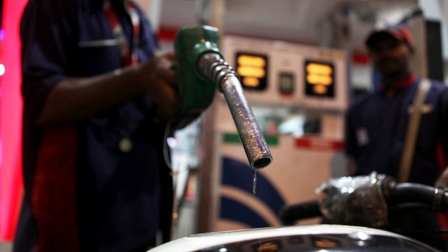 A car owner gets his fuel tank filled with petrol from a petrol pump at Prabhadevi. (Sattish Bate/Hindustan Times via Getty Images)