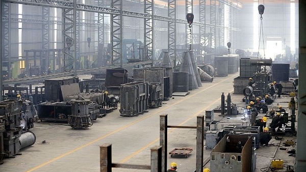 Indian workers at a heavy fabrication manufacturing factory in Vasna Buzarg village, near Ahmedabad in December 2016. (SAM PANTHAKY/AFP/Getty Images)