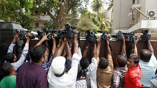 Video journalists flooding a residence. (Pratham Gokhale/Hindustan Times via Getty Images)