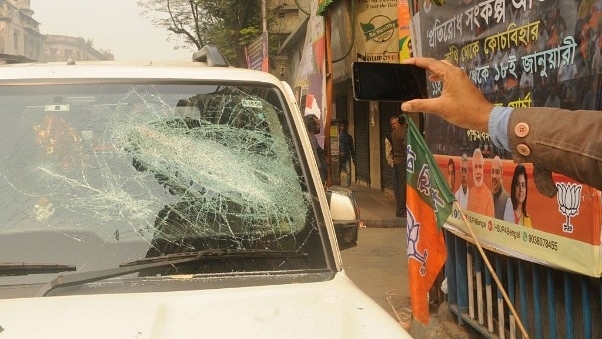 A BJP supporter’s damaged car in front of the party office after tension between BJP and Trinamool supporters in Kolkata. (Samir Jana/Hindustan Times via Getty Images)