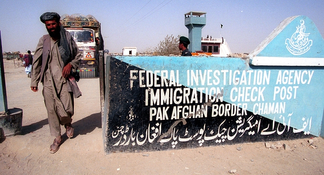 Afghan refugees walk near the Chaman border crossing with  Pakistan. (Koichi Kamoshida/Getty Images)