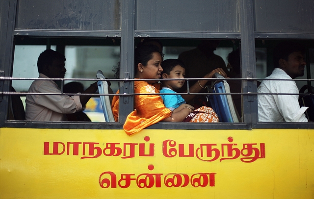  A lady with a young boy on her lap look out the window as they ride the bus. The transport employees have been risking their lives to ensure the communters’ safety. (Mark Kolbe/Getty Images)