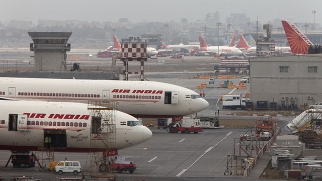 Air India aircraft are seen parked on the tarmac of the international airport in Mumbai. (Sattish Bate/Hindustan Times via Getty Images)