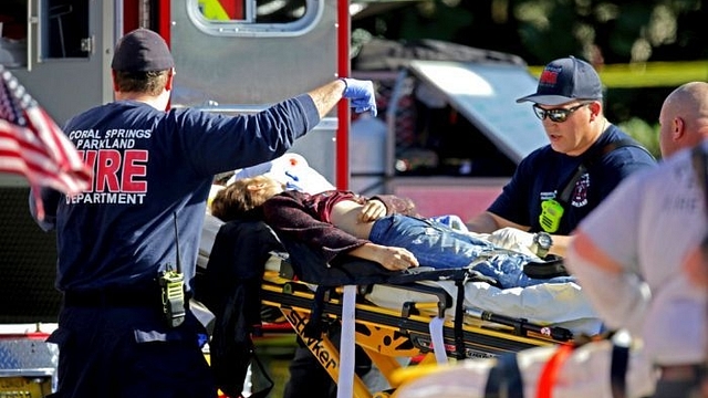 Medical personnel tend to a victim on a stretcher.