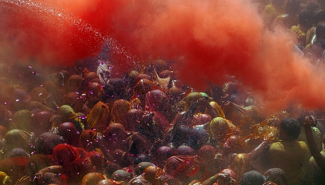 Hindu devotees play with coloured powders during Holi celebrations at the Bankey Bihari Temple in Vrindavan, India. (Majid Saeedi/Getty Images)