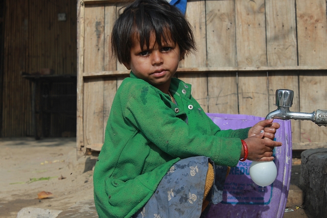A kid from a Sindh family saving water in a Holi balloon