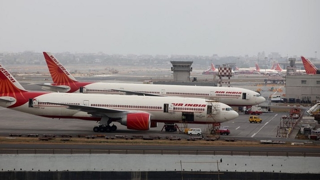 Air India aircraft are seen parked on the tarmac of the international airport in Mumbai. (Sattish Bate/Hindustan Times via Getty Images)