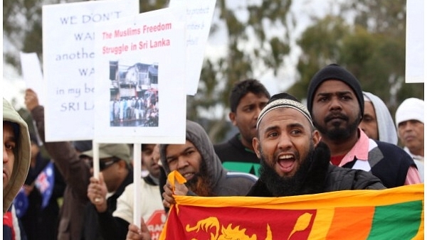 A protester chants ‘no more racism’ at Parliament House on June 26, 2014 in Canberra, Australia. (Cole Bennetts/Getty Images)