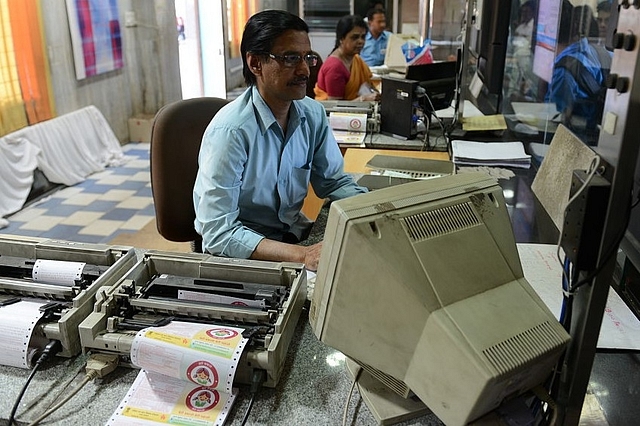 Employees at an Indian Railways ticketing counter. (Hemant Mishra/Mint via Getty Images)