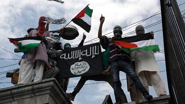  Kashmiri protesters hold up a flag of ISIS during a protest against Israeli military operations in Gaza, in Srinagar. (Waseem Andrabi/Hindustan Times via Getty Images)