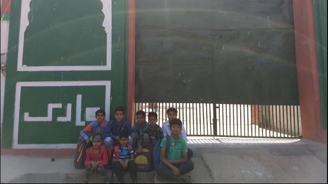 Children of Qaumi Sr. Sec. School in front of main entrance of the school.