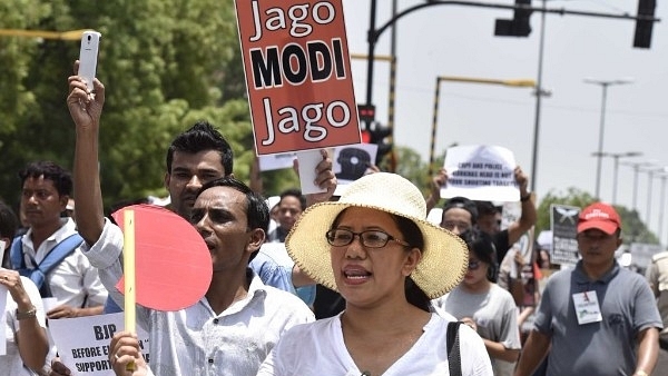 Protesters march carrying the flag depicting 110 years of their struggle for separate state and demanding the separate state Gorkhaland. (Arvind Yadav/Hindustan Times via Getty Images)