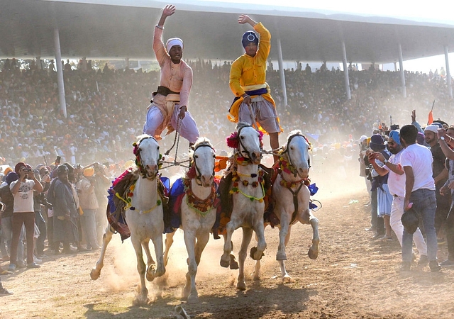 Nihangs performing horse riding skills during the Hola Mohalla festival at Anandpur Sahib. (Sanjeev Sharma/Hindustan Times via Getty Images)