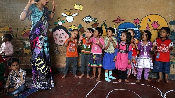 A teacher leads a lesson at Katha Community School in the Govindpuri slum district in Delhi. (Chris Jackson/Getty Images)