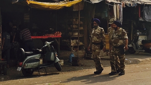 CRPF personnel taking a stroll in a street in Delhi’s Trilokpuri area.