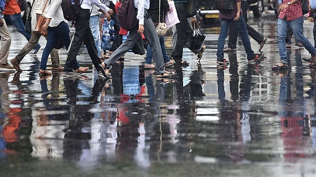  Pedestrians crossing a wet road after a heavy shower in Mumbai. (Arijit Sen/Hindustan Times via Getty Images)