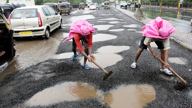 Potholes being patched up (Manoj Patil/Hindustan Times via Getty Images)