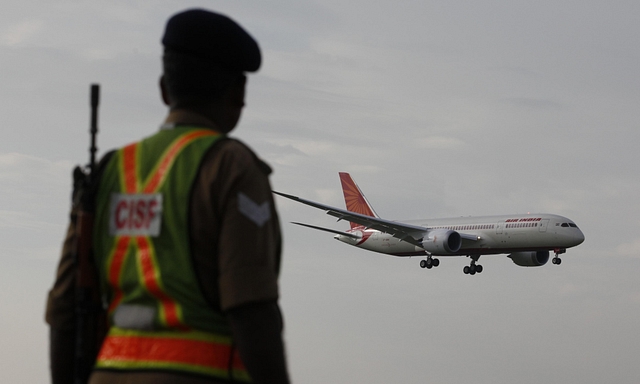  Security person watch as the new member of Air India advanced Boeing 787 Dreamliner touched down at IGI airport. (Raj k Raj/Hindustan Times via Getty Images)‘