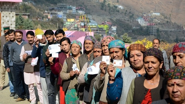 Women showing their voting cards before casting their votes for Himachal assembly elections at Theog in Shimla. (Deepak Sansta/Hindustan Times via Getty Images)