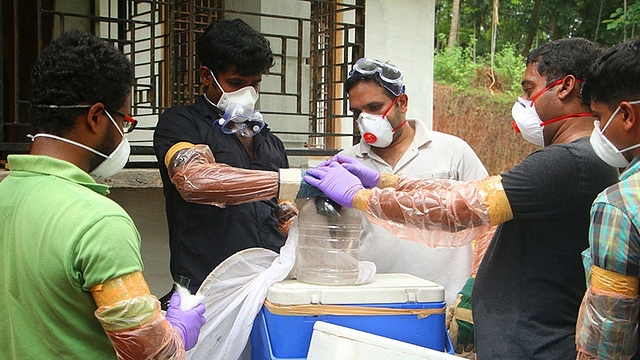 Medical staff examining samples. (via Science News)&nbsp;