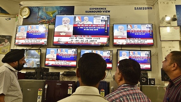  People watching an address by Narendra Modi. (Sanjeev Verma/Hindustan Times via Getty Images)