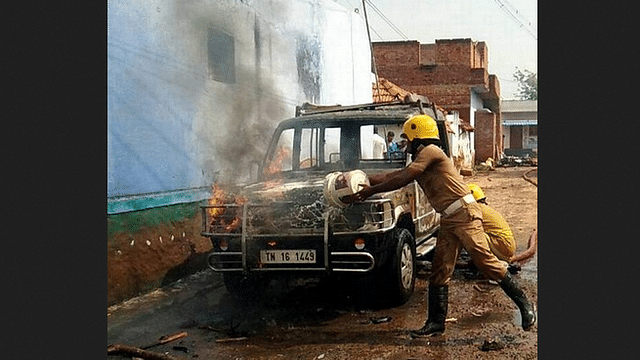 Fire station personnel putting out a blaze engulfing a vehicle in Bomminaickanpatti.