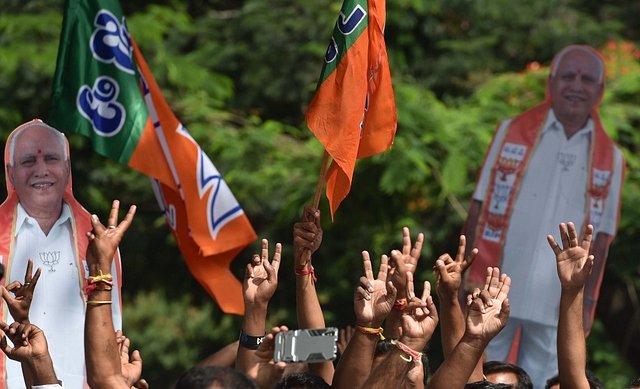 BJP supporters celebrate as B S Yeddyurappa takes oath as Chief Minister at Raj Bhawan on 17 May 2018 in Bengaluru. (Arijit Sen/Hindustan Times via GettyImages)&nbsp;