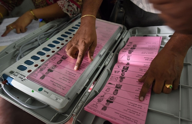 A polling staff tallies the candidates names on the Electronic Voting Machines (EVM) (Arijit Sen/Hindustan Times via Getty Images)