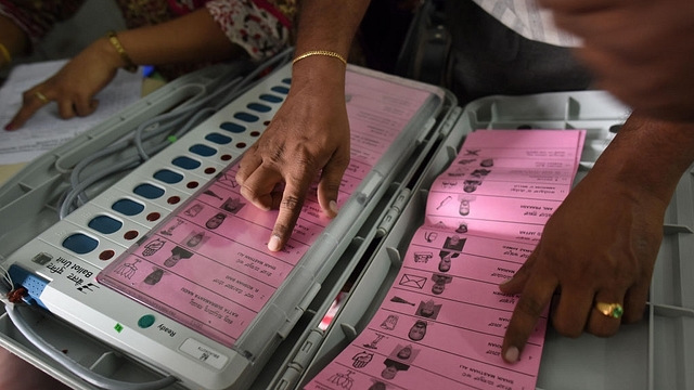 A polling staff tallies the candidates names on the Electronic Voting Machines (EVM) (Arijit Sen/Hindustan Times via Getty Images)