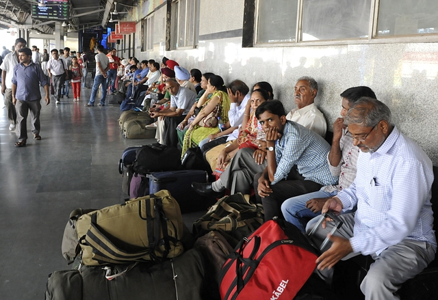 Passengers sitting on the platform at New Delhi Railway Station (onu Mehta/Hindustan Times via Getty Images)