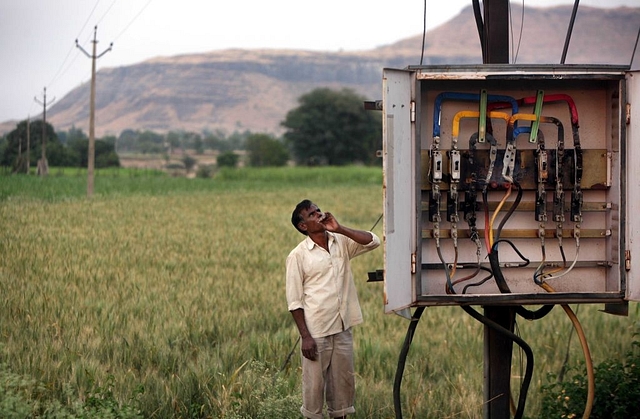 A farmer looks at a transformer next to his field in Chandapuri, Ahmednagar. (Vikas Khot/Hindustan Times via Getty Images)