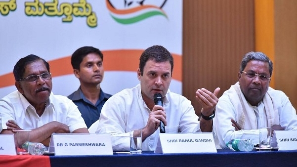 All India Congress Committee president Rahul Gandhi flanked by Karnataka Pradesh Congress Committee president G Parmeshwara (L) and Karnataka Chief Minister Siddaramaiah (R) during a press conference on the last day of campaigning ahead of state assembly election at a city hotel on 10 May 2018 in Bengaluru. (Arijit Sen/Hindustan Times via Getty Images)