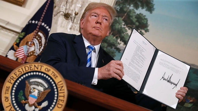 US President Donald Trump holds up a memorandum that reinstates sanctions on Iran after he announced his decision to withdraw the US from the 2015 Iran nuclear deal in&nbsp; Washington. (Chip Somodevilla/Getty Images)&nbsp;