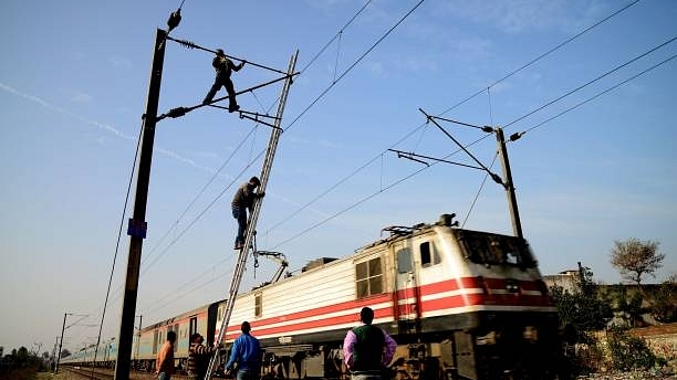 Indian Railways workers repair high voltage train power lines in Jalandhar (Photo credits should read SHAMMI MEHRA/AFP/Getty Images)