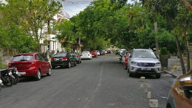 Cars parked on a road in Bengaluru.&nbsp;