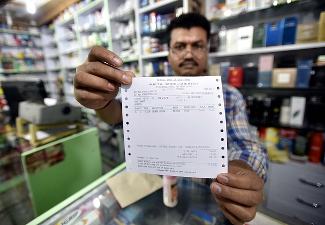 A shopkeeper showing new updated GST bill at the store in Delhi (Ravi Choudhary/Hindustan Times via Getty Images)