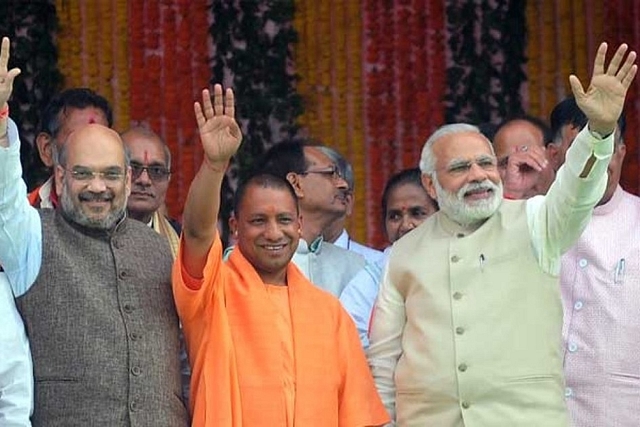 Amit Shah and Yogi Adityanath with Prime Minister Narendra Modi